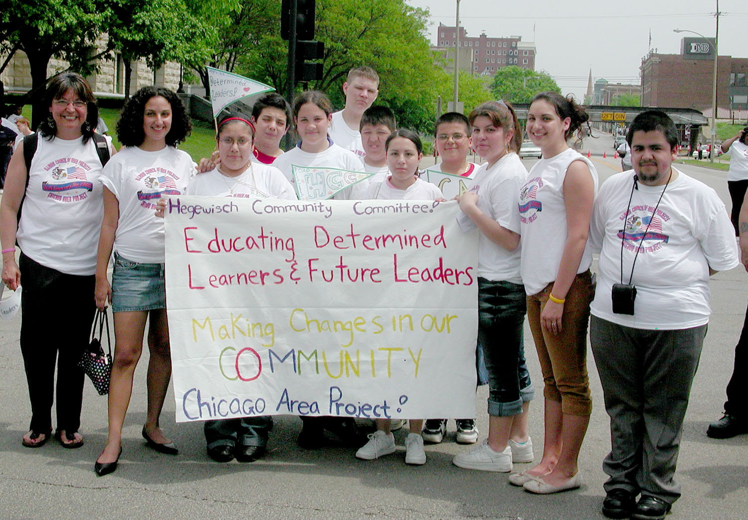 Hegewisch Community Committee members gathering around their community leadership banner