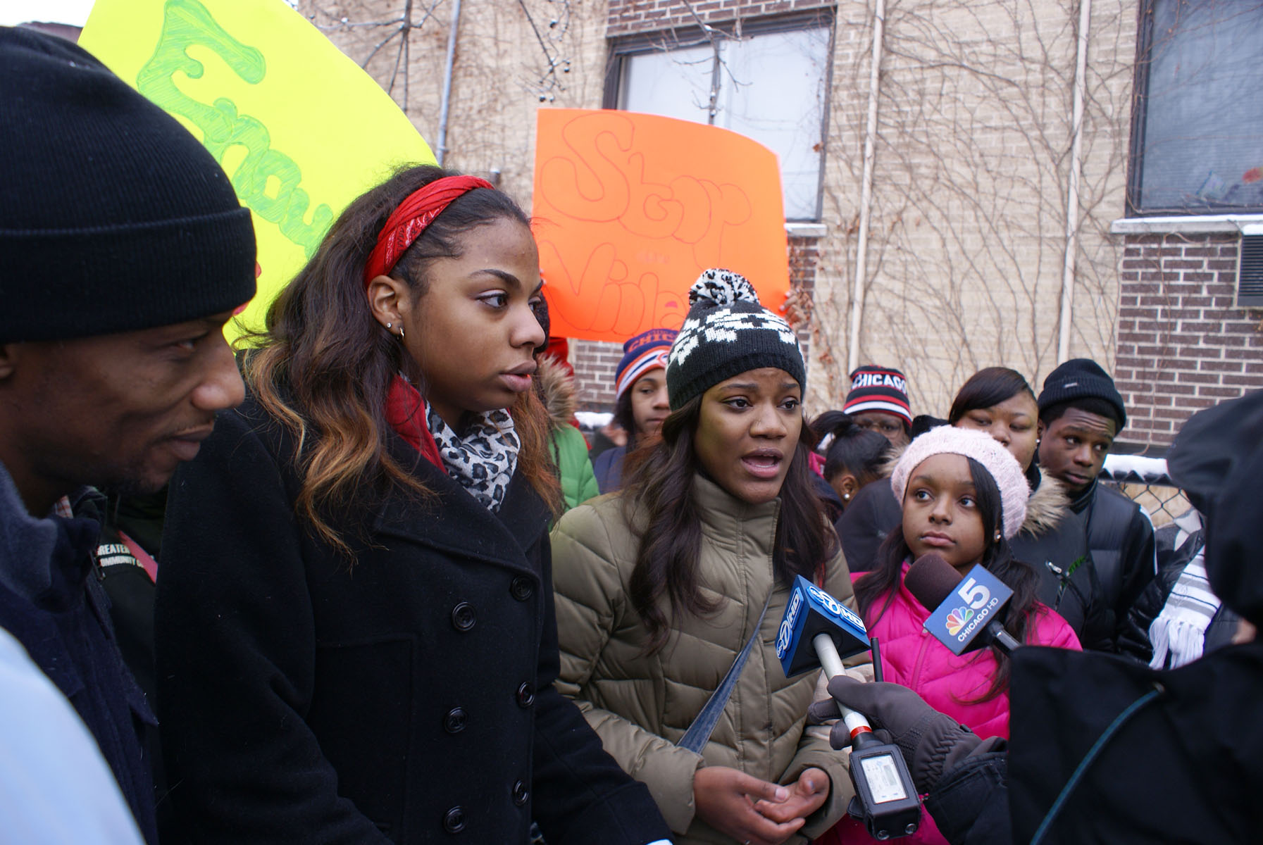 Young community advocates speaking with Chicago news media